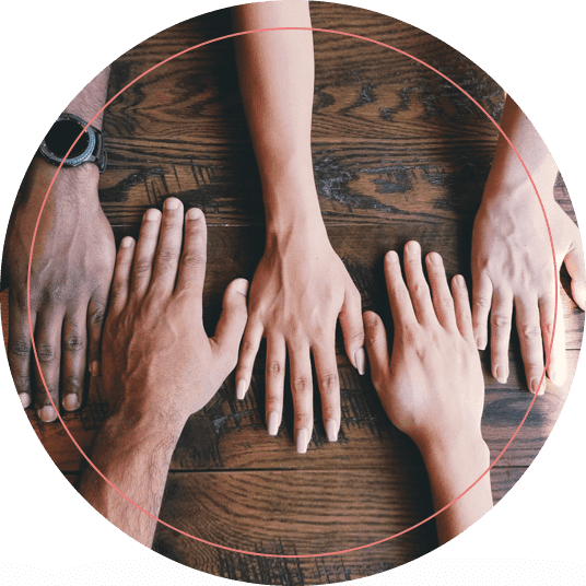 People Holding Out Hands on a Table From Both Sides